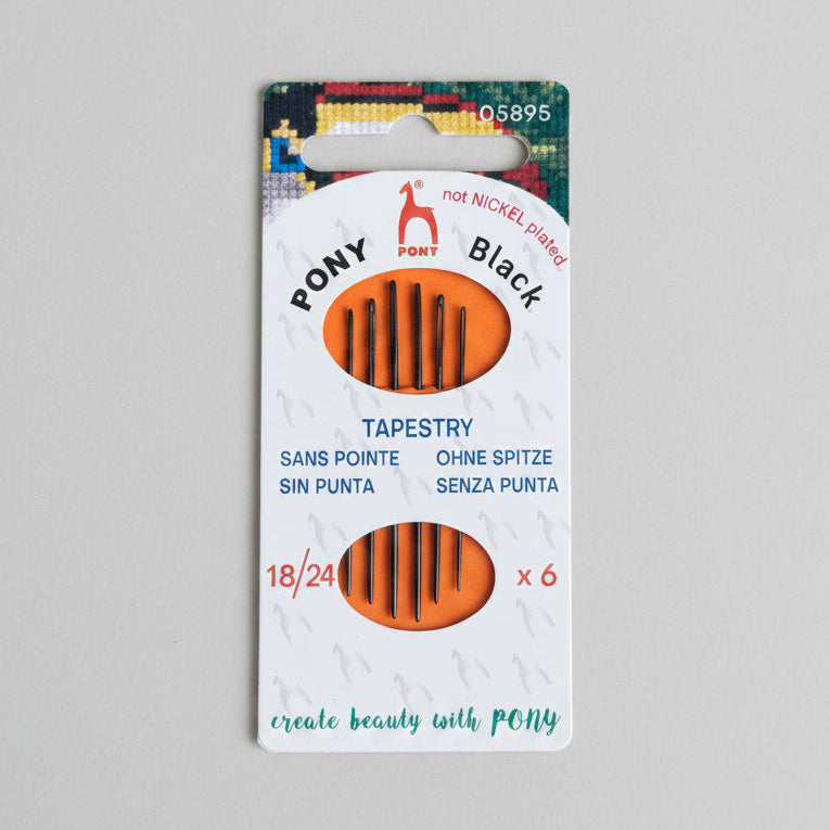 Pony black tapestry needle packaging on a light gray background with green leaves.