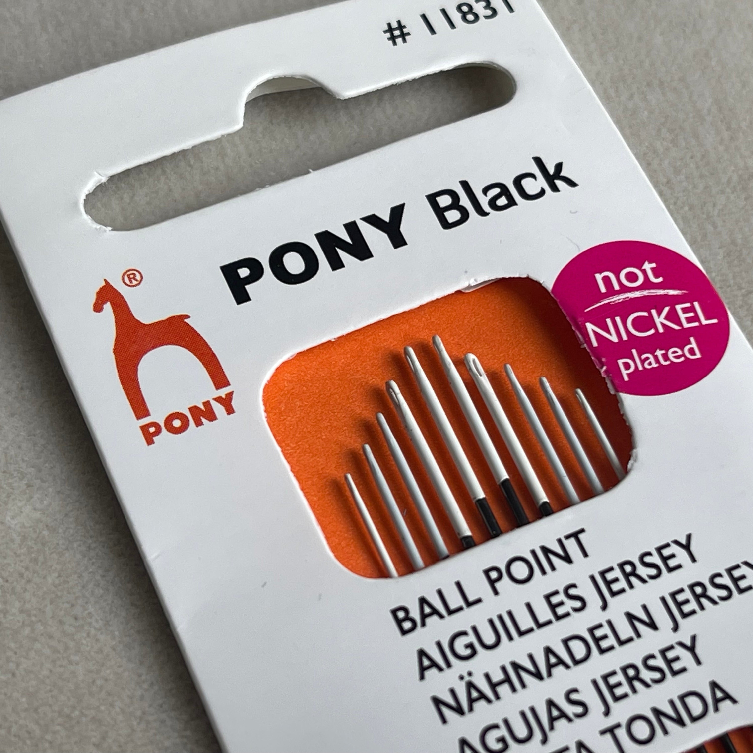 Packaging of Pony Black ballpoint needles on a gray background